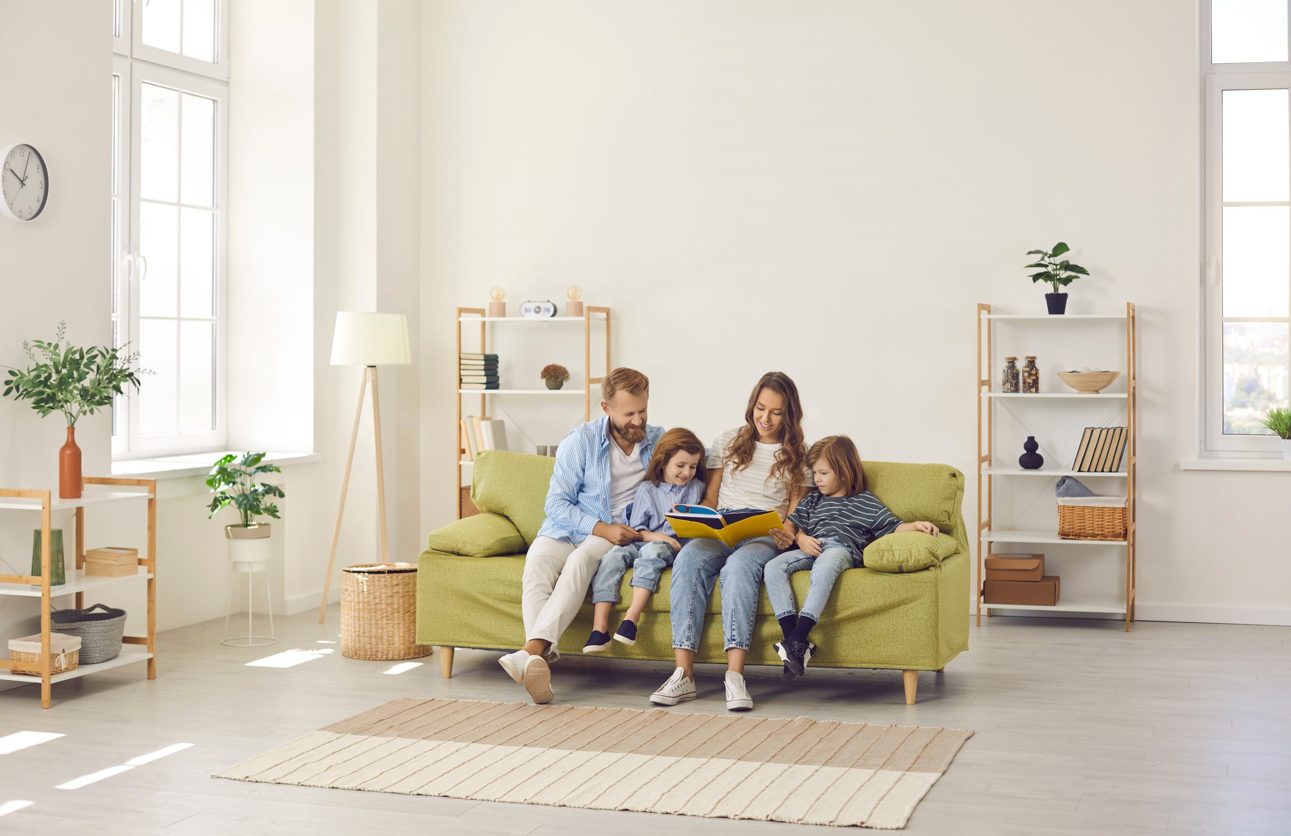 Family in Living Room sitting on Couch.